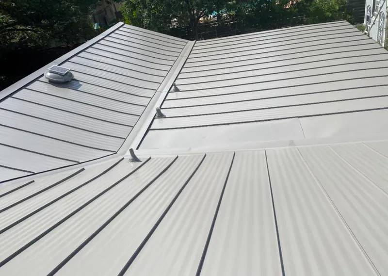 Solar attic fan installed on a metal roof for Roof Ventilation in Jersey City
