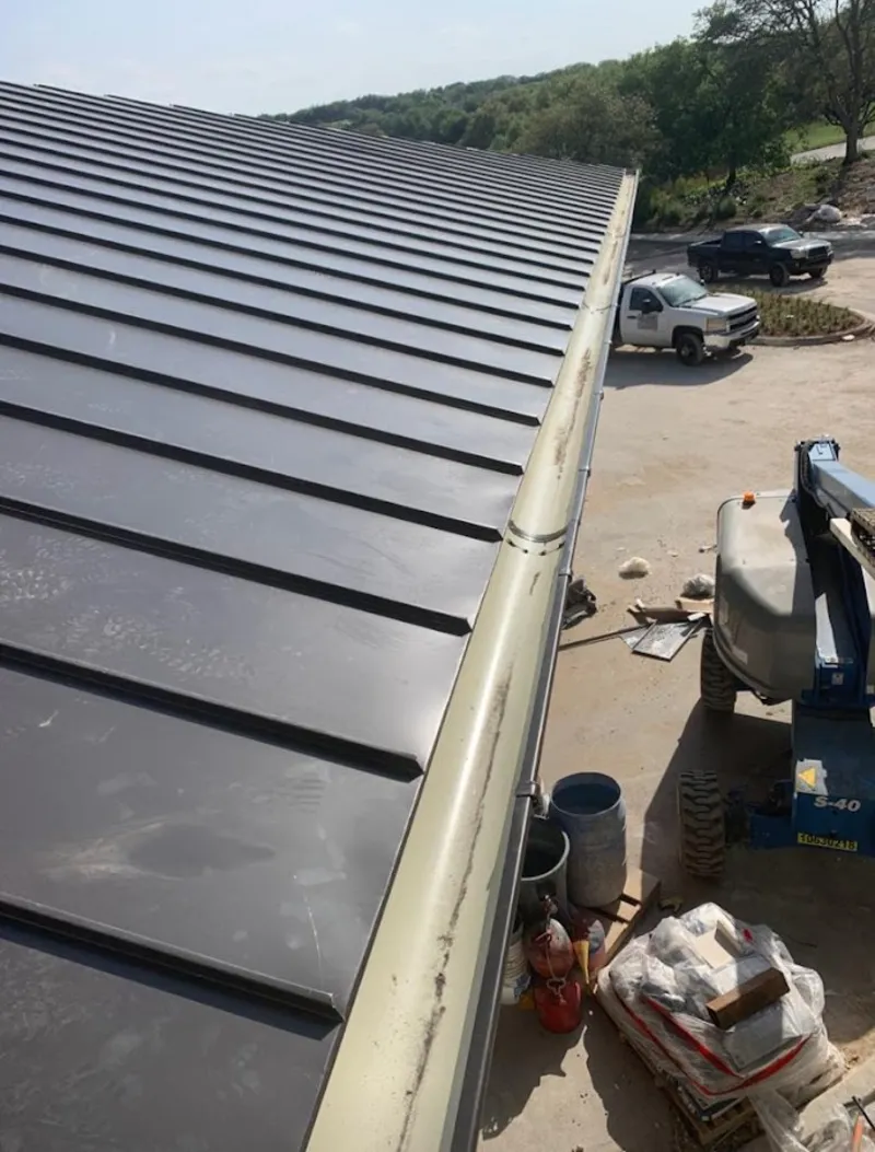 Standing seam panel and gutter detail on a metal roofing jobsite in Jersey City